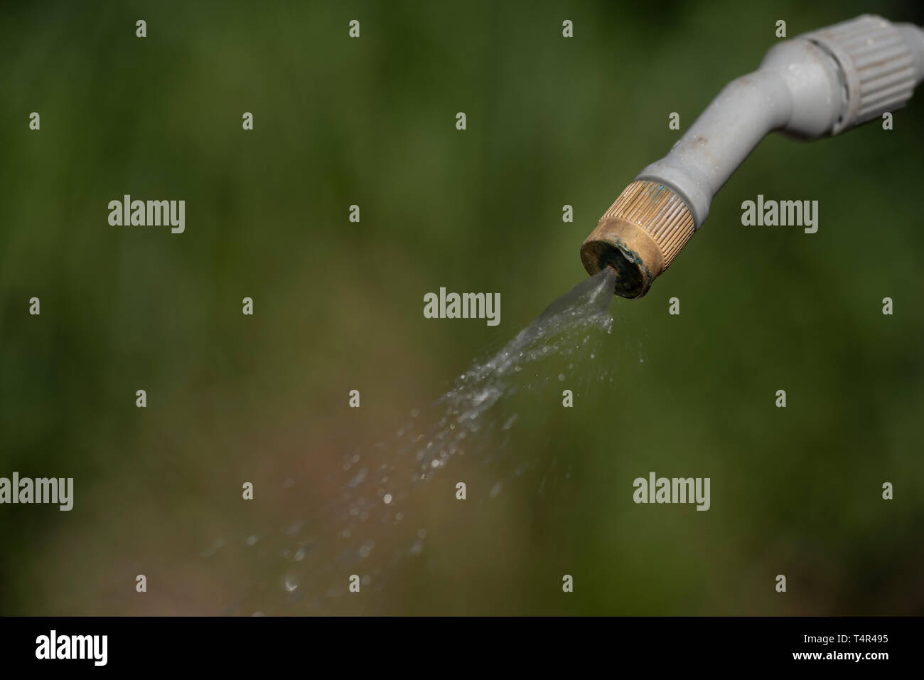 Spray nozzle releasing liquid Stock Photo Alamy