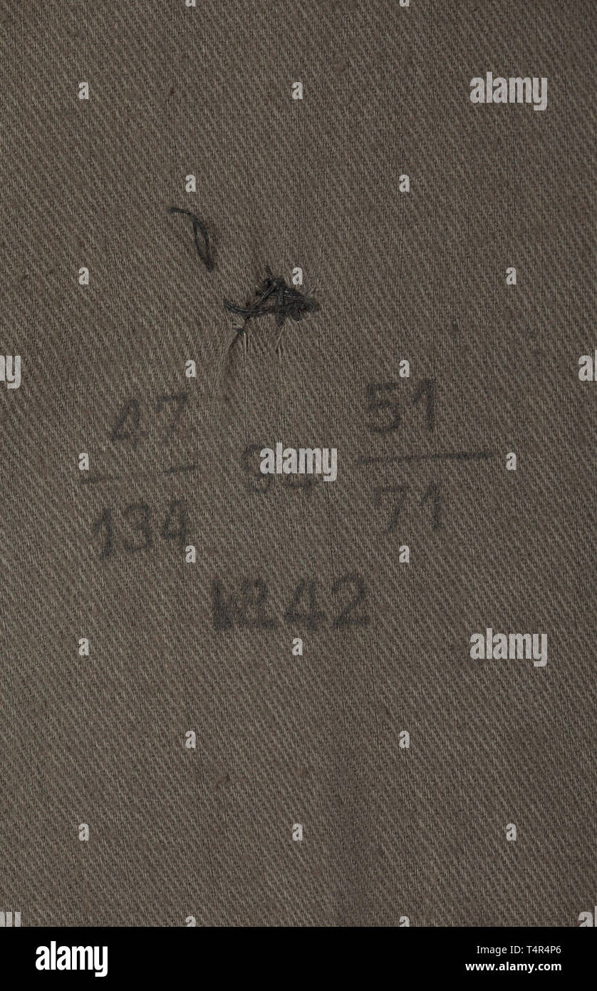 An overcoat for army personnel depot piece from the year 1942 Issue with large collar in field-grey woollen cloth, field-grey buttons, depot- and size stamps from 1942 in brownish cotton liner. historic, historical, army, armies, armed forces, military, militaria, object, objects, stills, clipping, clippings, cut out, cut-out, cut-outs, 20th century, Editorial-Use-Only Stock Photo
