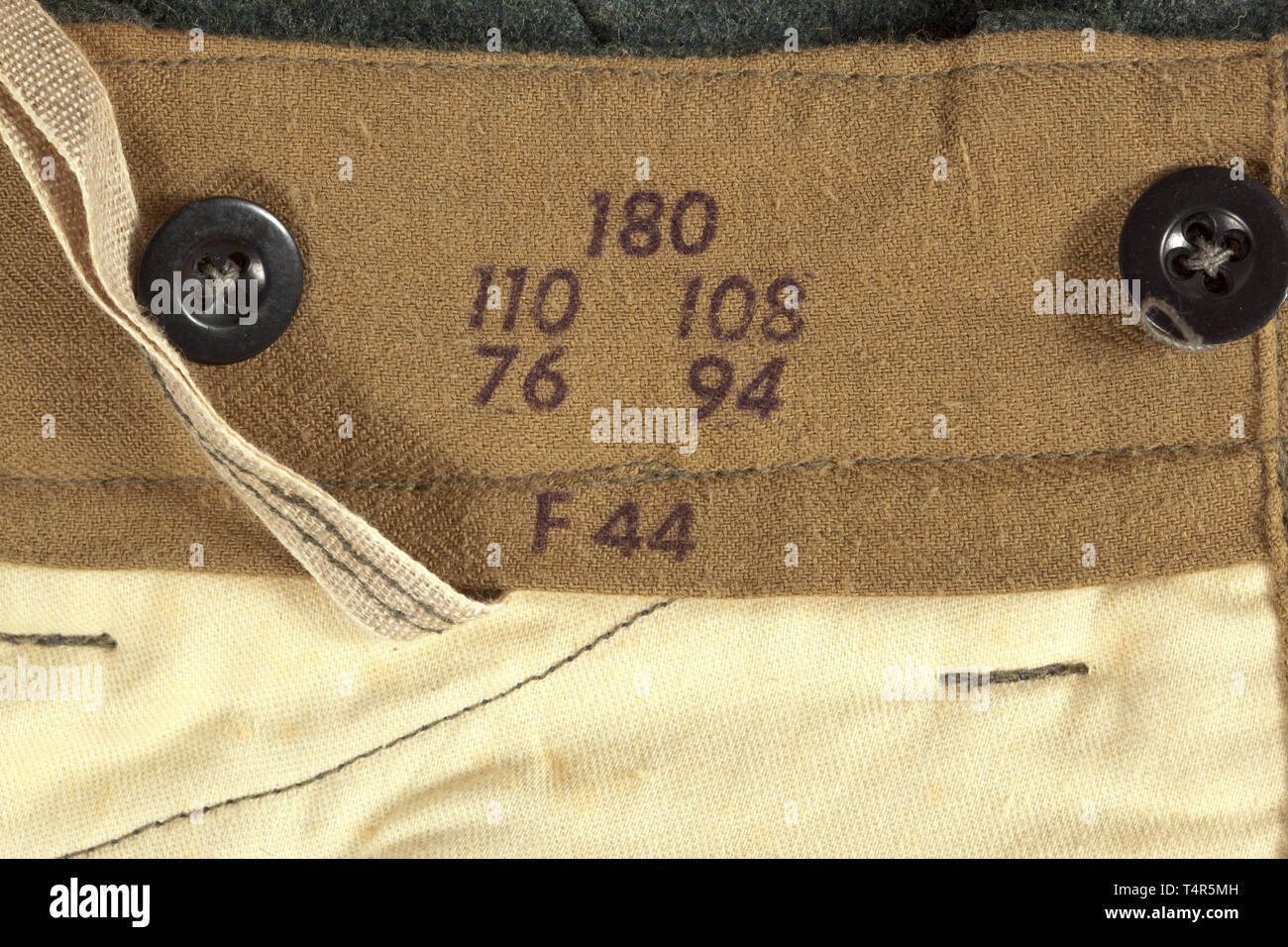 A pair of trousers for paratroopers depot piece with Reich factory number from 1944 Field-grey reprocessed wool with pocket sacks in white cotton, inner liner and reinforcements in sand-coloured herringbone pattern. Raised back, two of the eight belt loops suitable for the attachment of suspenders, covered fly with blue glass buttons. The flaps of the integrated fob pocket and those of the diagonal front pockets are each closable through a field-grey painted Prym push button, that on the right side with a supplemental diagonally sloping flap for the jack knife, closable wit, Editorial-Use-Only Stock Photo