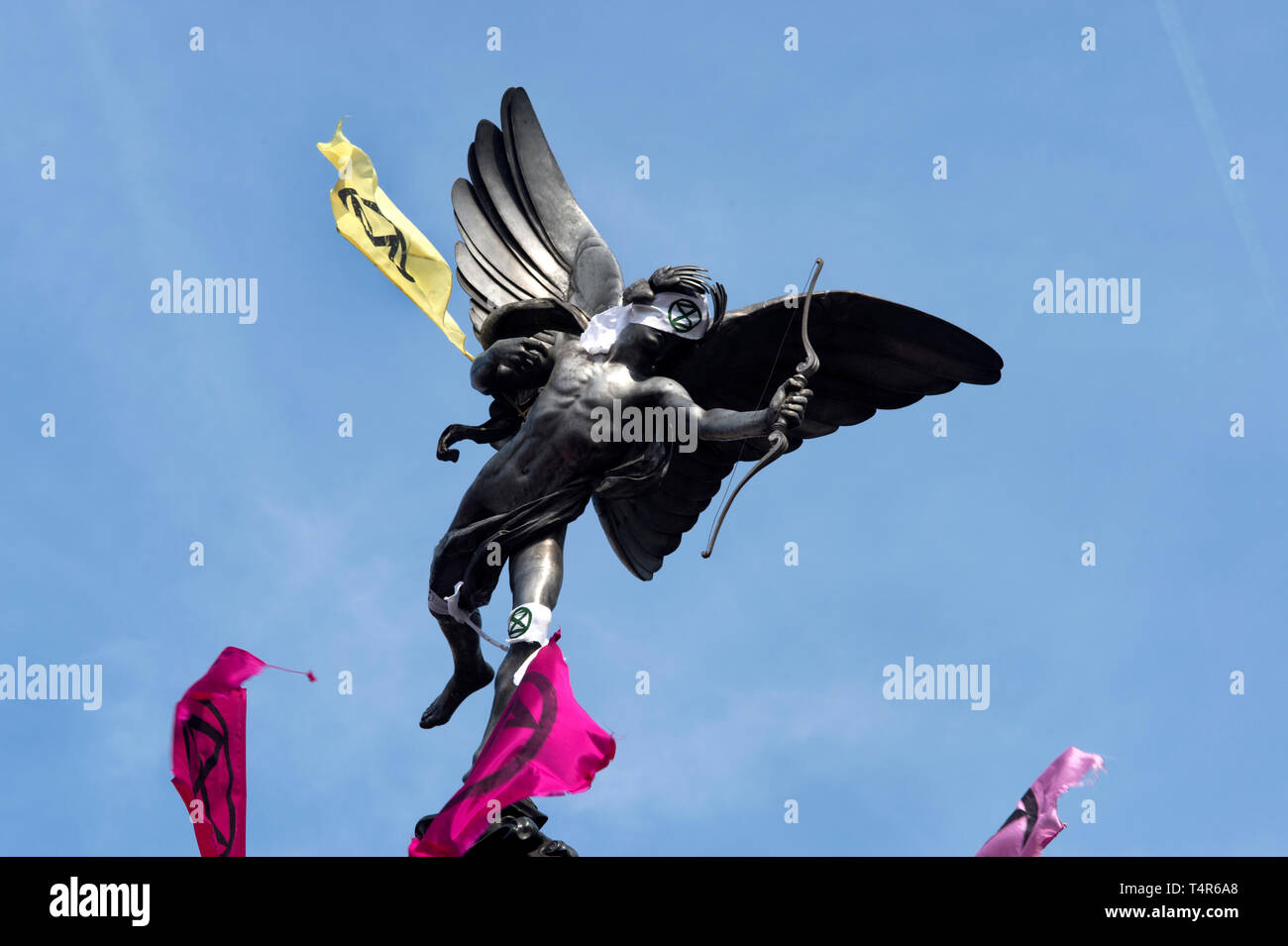 London April 15th 2019. Extinction Rebellion protest to demand action on climate change. Piccadilly Circus. Statue of Eros with blindfold and flags. Stock Photo