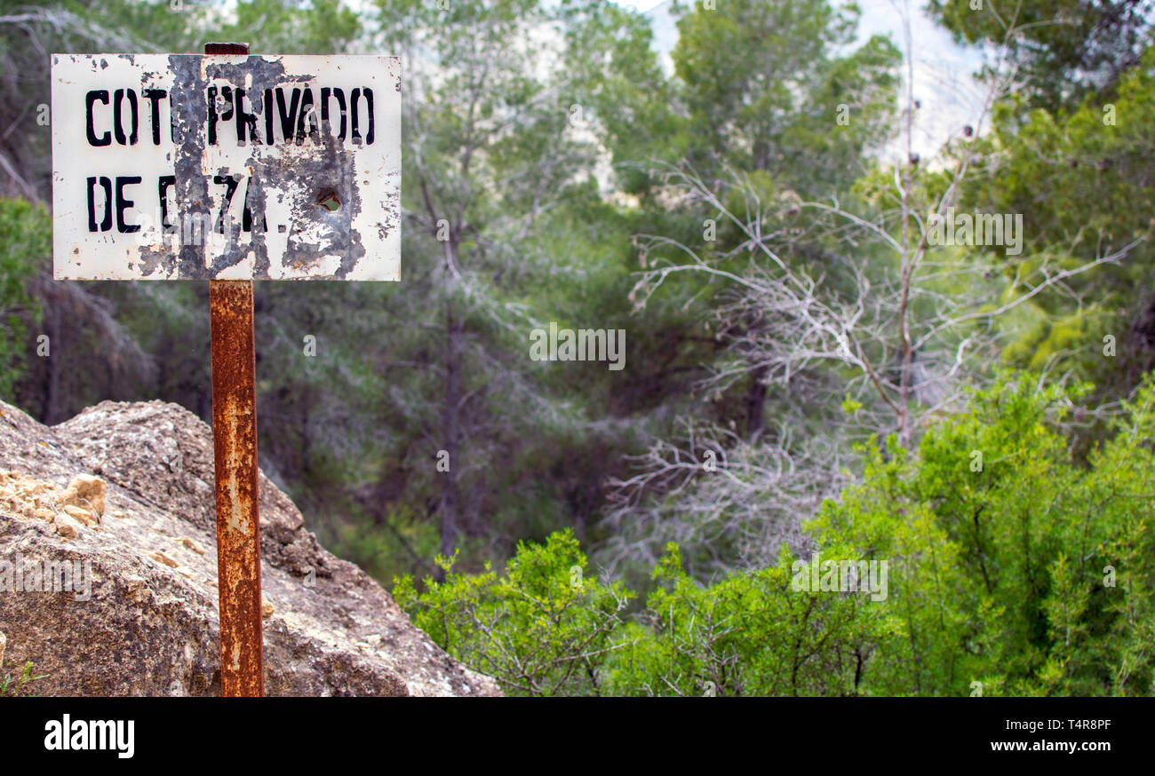 Sign in the field of Private property prohibition against a landscape. Restricted access in Murcia Spain 2019. Private area. Warning sign to no trespassing. Stock Photo