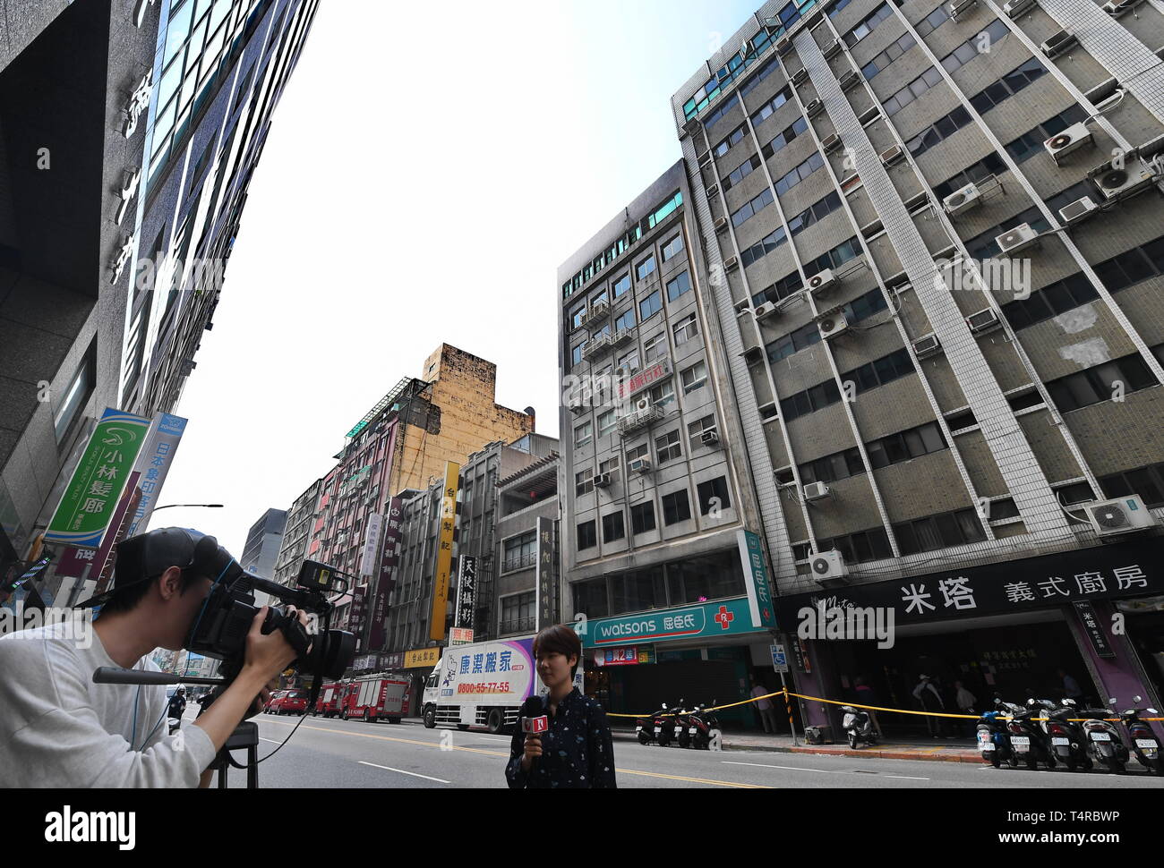 (190418) -- TAIPEI, April 18, 2019 (Xinhua) -- Reporters work in front of a building affected by a 6.7 magnitude earthquake in Taipei, southeast China's Taiwan, April 18, 2019. A 6.7 magnitude earthquake jolted a sea area near Hualien County in Taiwan at 1:01 p.m. Thursday, according to the China Earthquake Networks Center (CENC). The epicenter was monitored at 24.02 degrees north latitude and 121.65 degrees east longitude, at a depth of 24 km, the center said. No immediate casualties were reported. (Xinhua/Zhang Guojun) Stock Photo