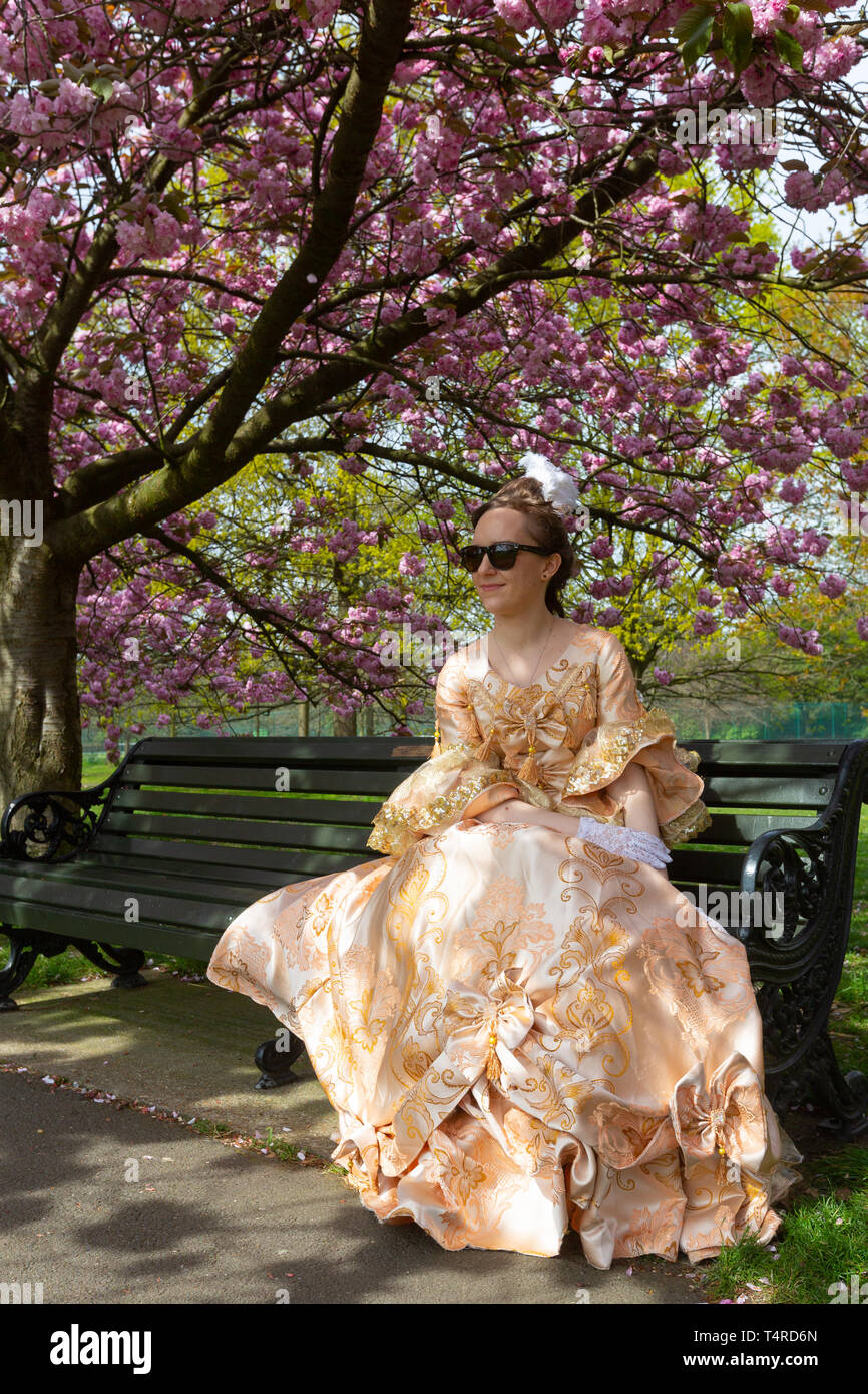 Greenwich, London, United Kingdom. 18th April, 2019. Londoner Aurelia enjoying the park.  The popular avenue of cherry blossom in Greenwich Park, south east London, continues to draw visitors. Rob Powell/Alamy Live News Stock Photo