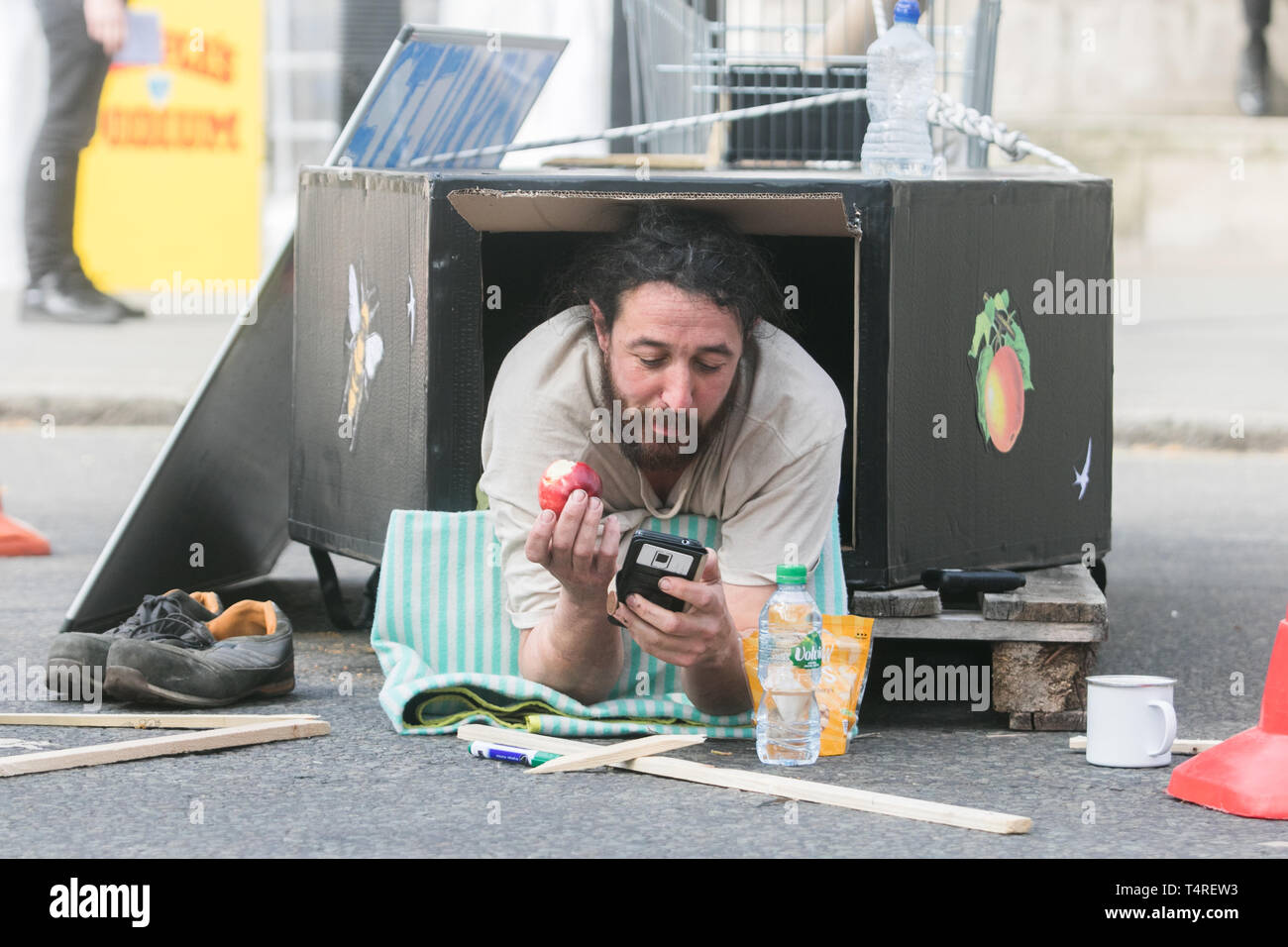 London, UK. 18th Apr 2019. A protester lying inside a makeshift coffin as Extinction Rebellion protesters continue to block access to Parliament Square on day 4 of an ongoing civil disobedience protest to demand the UK Government declare an emergency on the climate crisis Credit: amer ghazzal/Alamy Live News Stock Photo