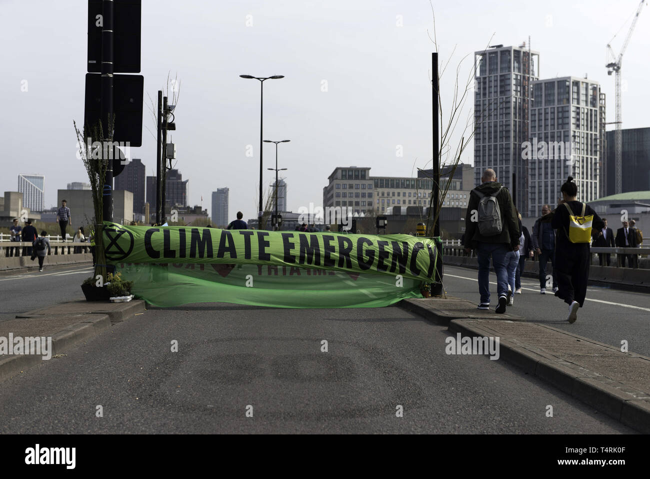 London, Greater London, UK. 18th Apr, 2019. Large Extinction Rebellion banner that reads Climate emergency is seen at Waterloo bridge blocking the street during the Extinction Rebellion Strike in London.Environmental activists from Extinction Rebellion movement hold for fourth consecutive day Waterloo Bridge in London. Activists has been parked a lorry on the bridge blocking the street causing disruptions. Police have been arresting protesters that refuse to head to Marble Arch. Extinction Rebellion demands from the government direct actions on the climate, reduce carbon emissi Stock Photo