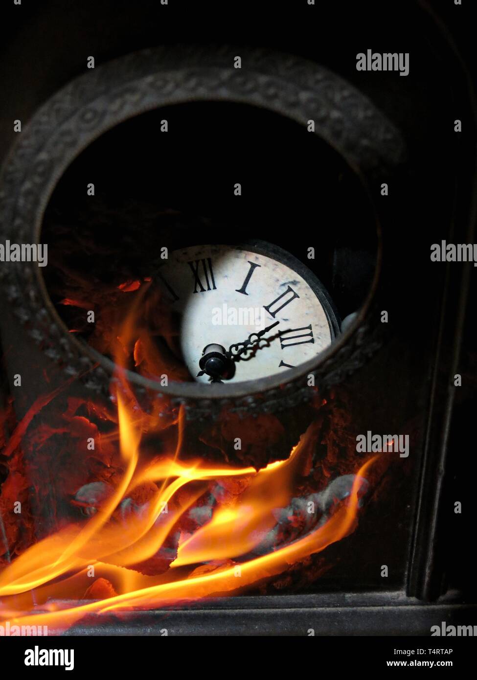 Broken antique clock on fire Stock Photo Alamy