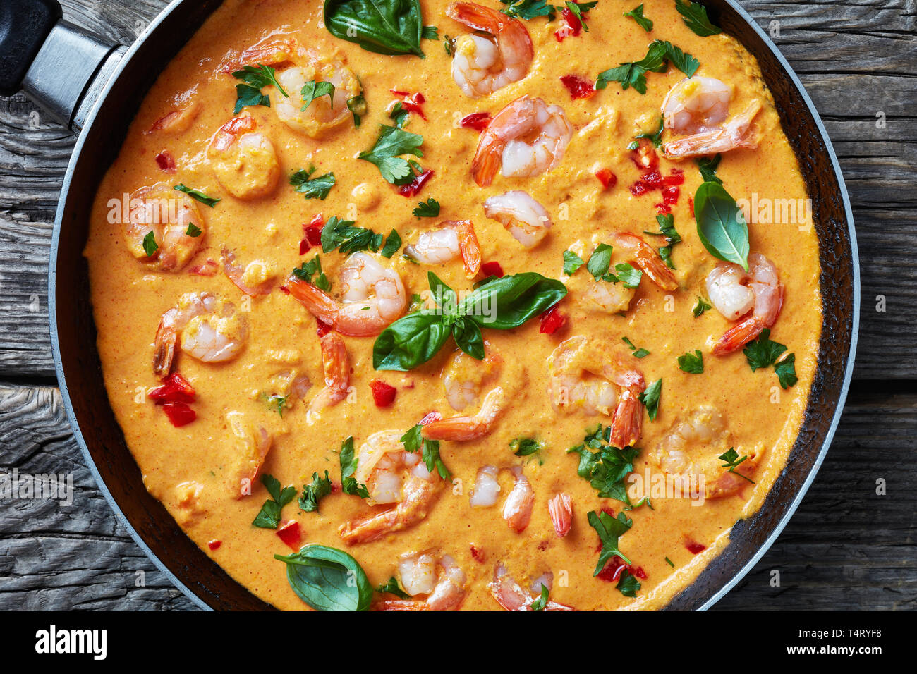 creamy, and comforting Shrimps in Coconut Sauce with blended vegetables, camarao no leite de coco, brazilian recipe, view from above, flat lay, close- Stock Photo