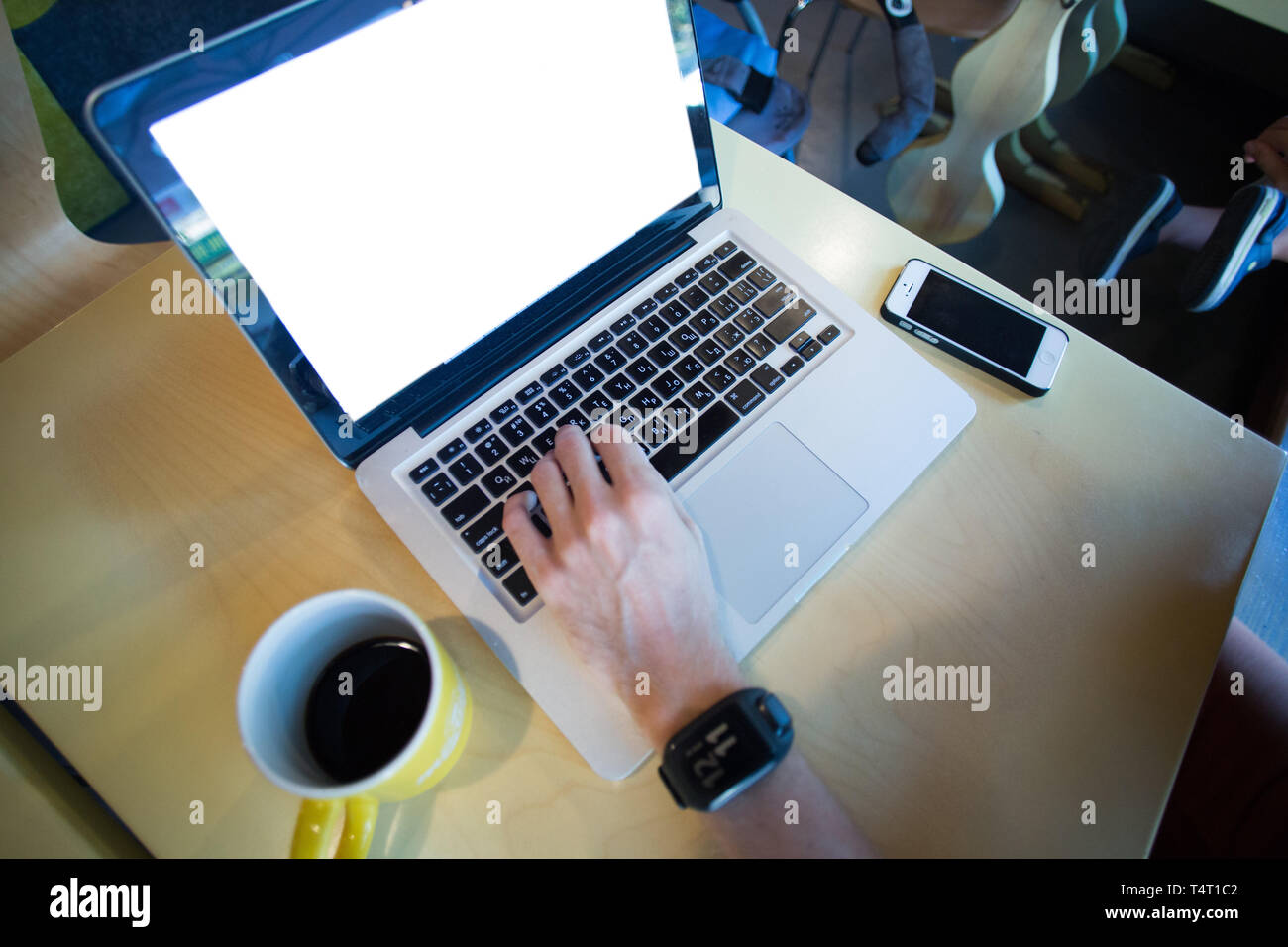 man using laptop with website and smartphone Stock Photo
