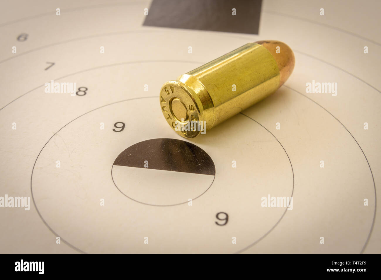45 Target 45 ACP bullet with a shooting target in the background Stock Photo - Alamy