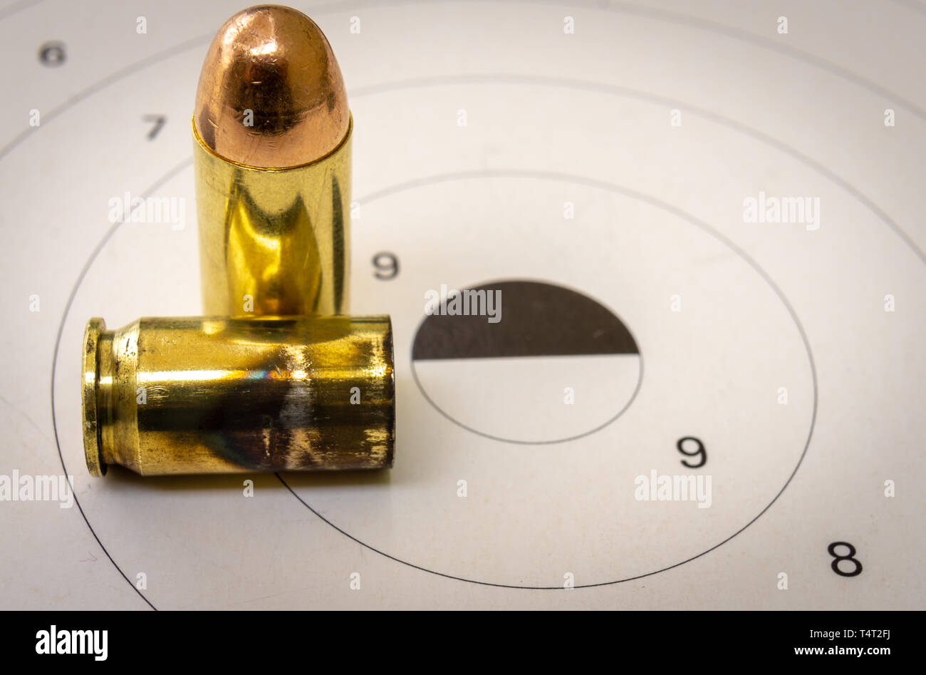 45 ACP bullet with a shooting target in the background Stock Photo