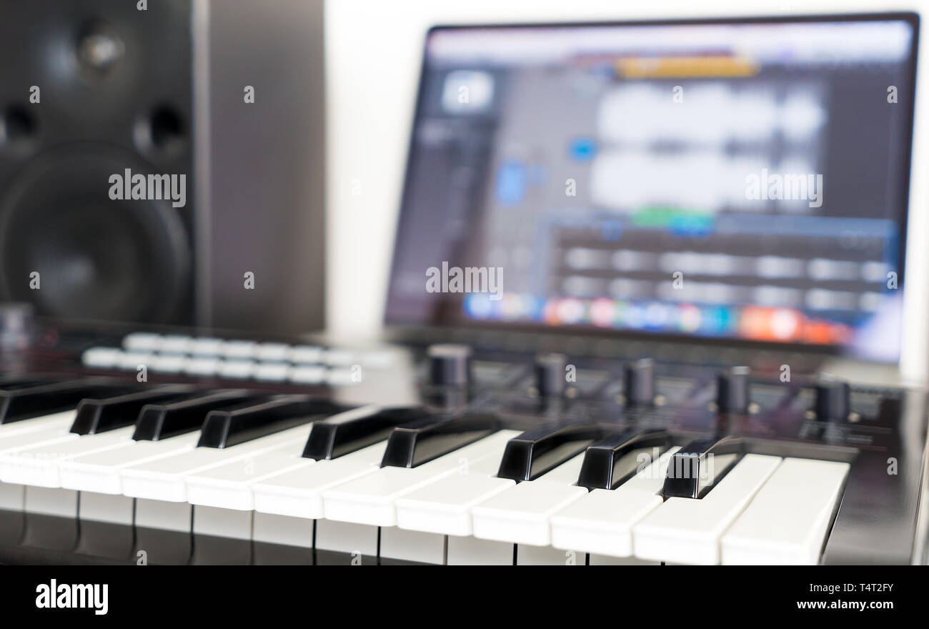 Synthesizer keyboard lying on Music studio working desktop Stock Photo