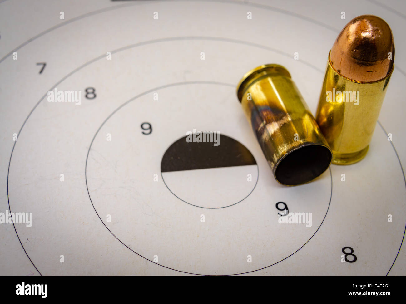 45 ACP bullet with a shooting target in the background Stock Photo