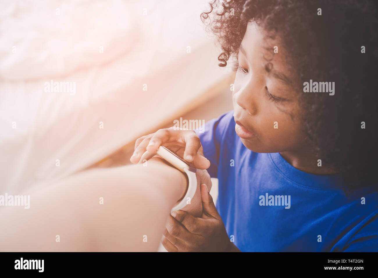 Little boy is playing with smart watch on a man wrist Stock Photo