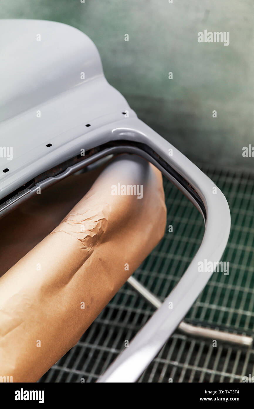 Car door with recent primer coat drying on rack Stock Photo Alamy