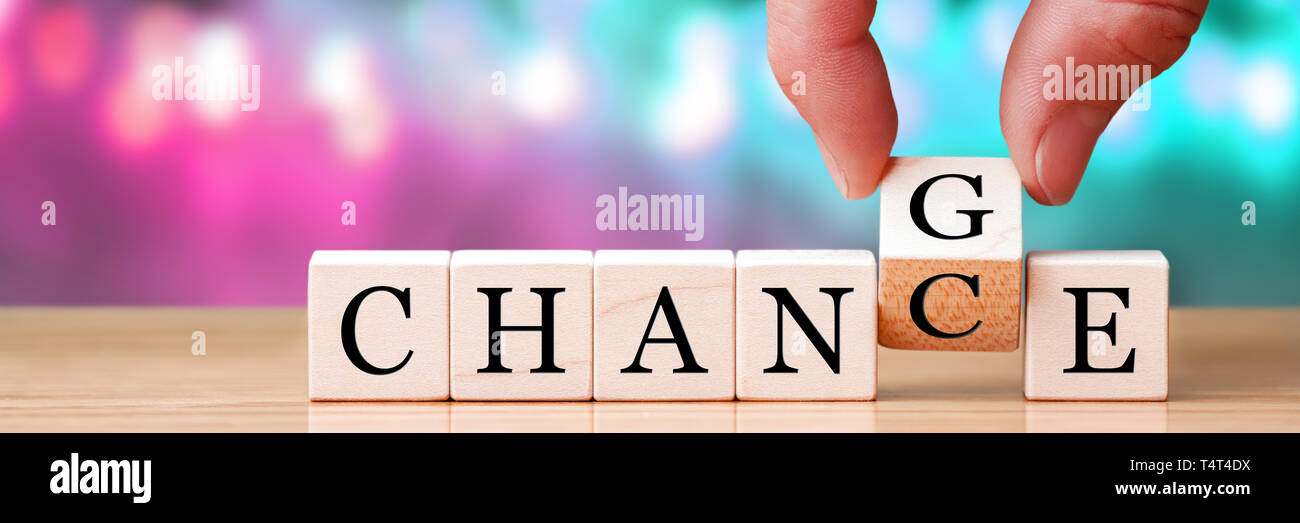 Hand Changing Word From Chance To Change On Wooden Cubes, New Years Resolution / Life Goals Concept Stock Photo