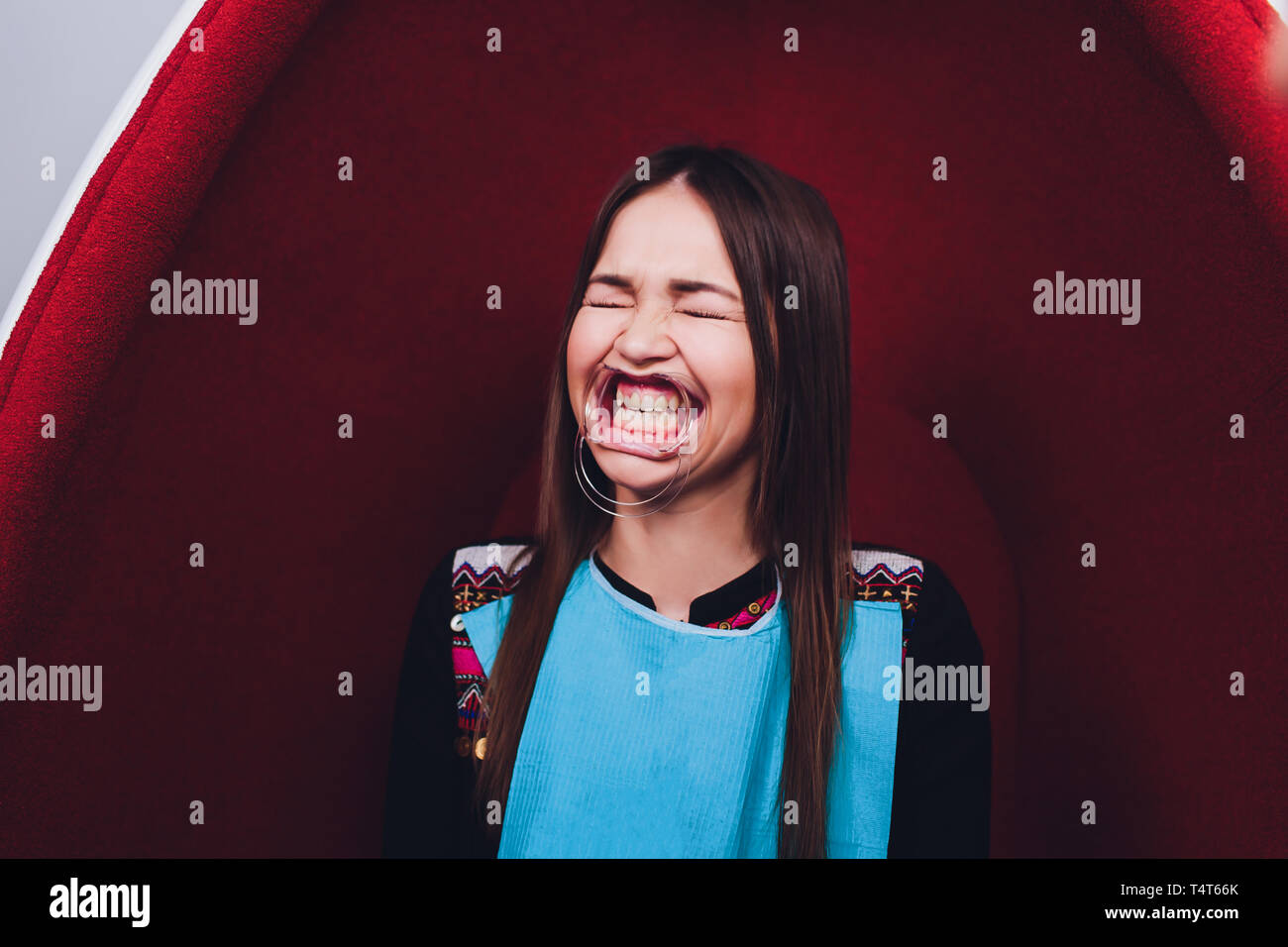 Close up of female mouth with retractor. Doctor flossing the teeth