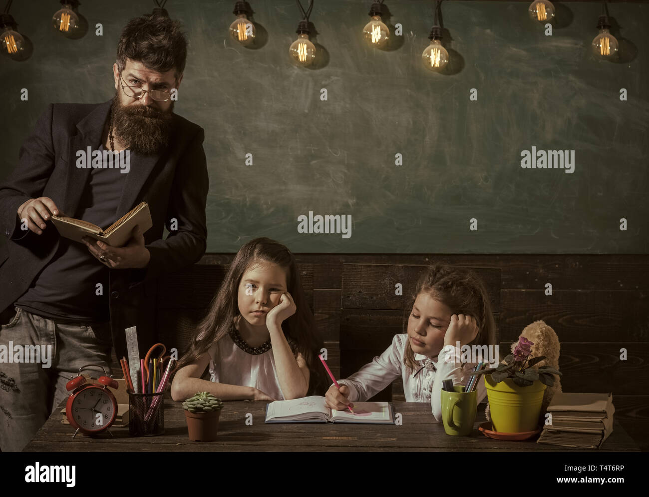 Boring lesson concept. Teacher and girls pupils in classroom ...