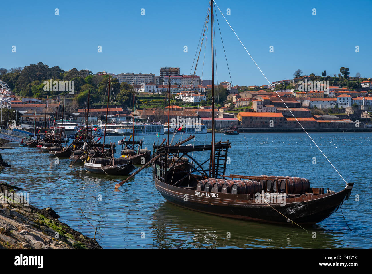 Rabelo boat with wine barrels on the Douro River, in front of Porto's ...