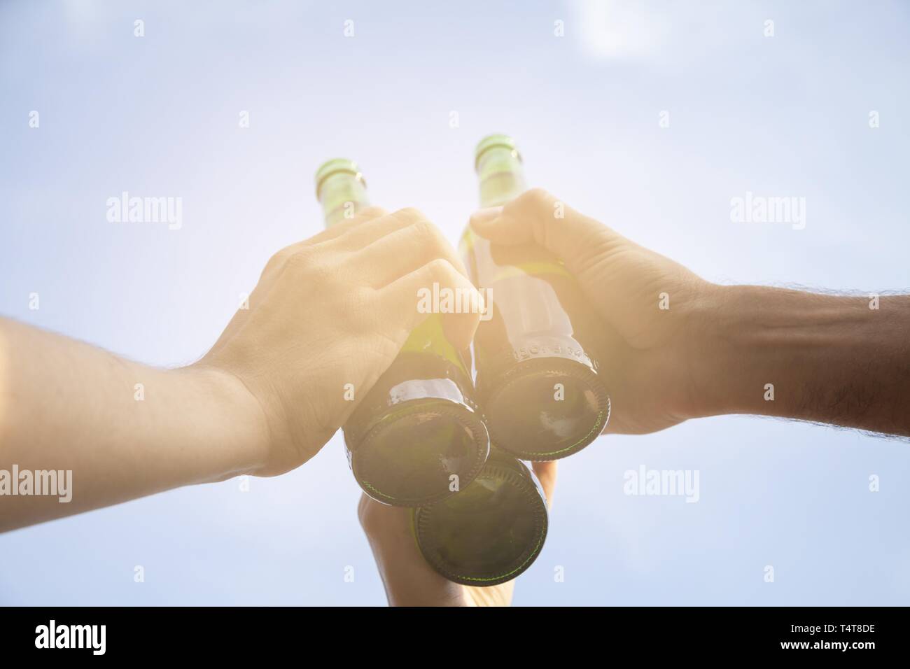 Make a toast with beer bottles, Germany Stock Photo