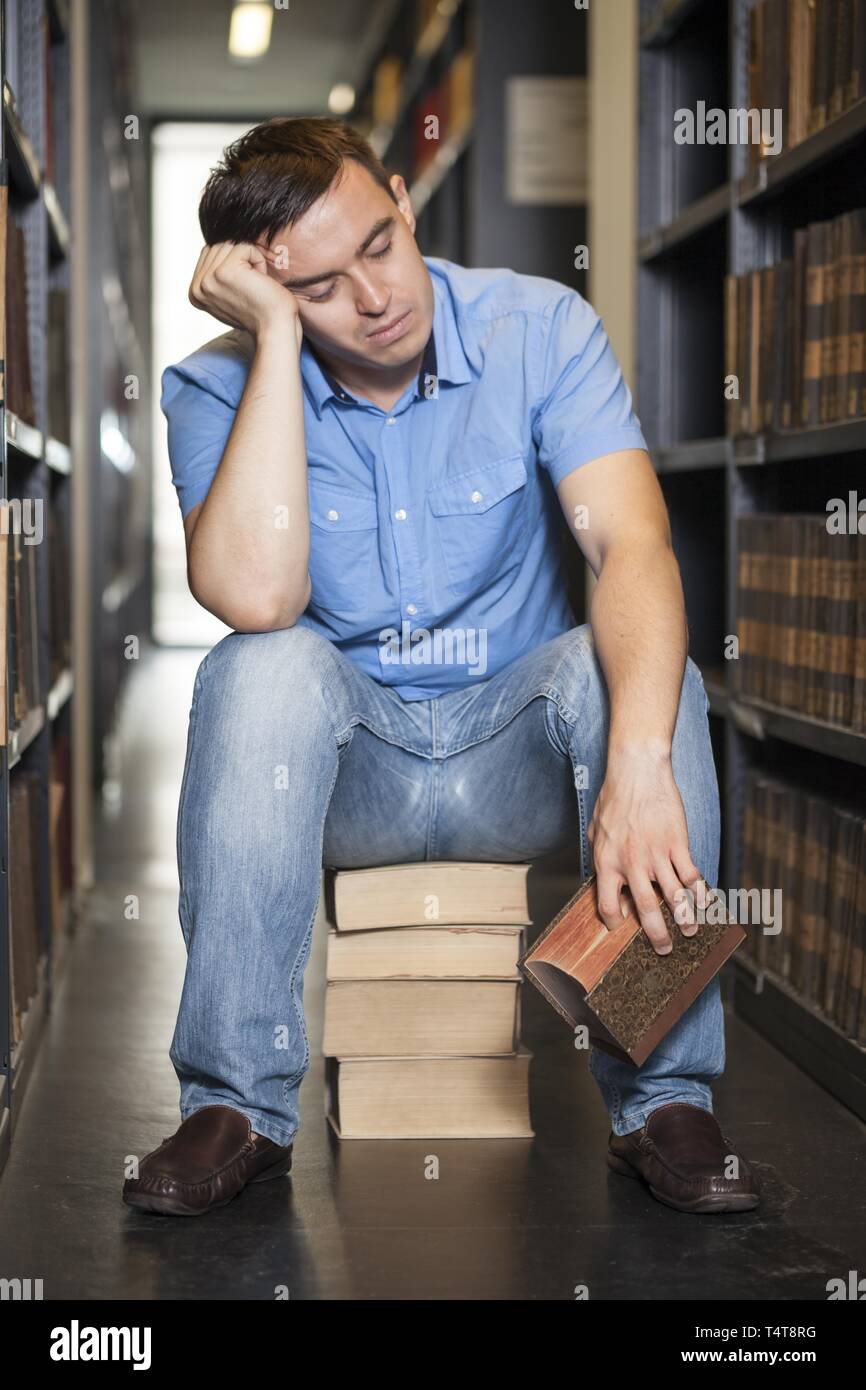 Student sleeping in library Stock Photo