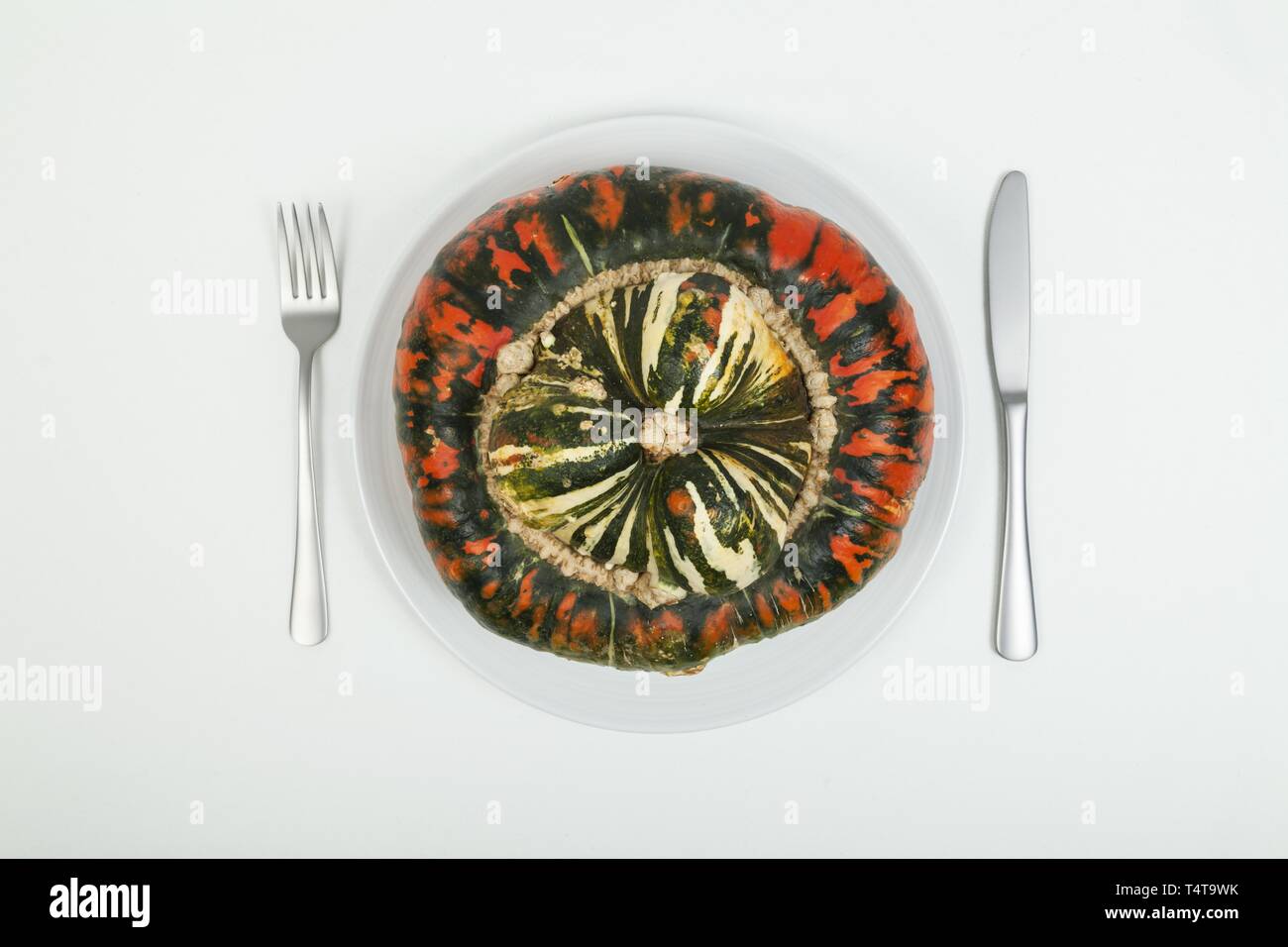 White plate, cutlery, pumpkin Stock Photo