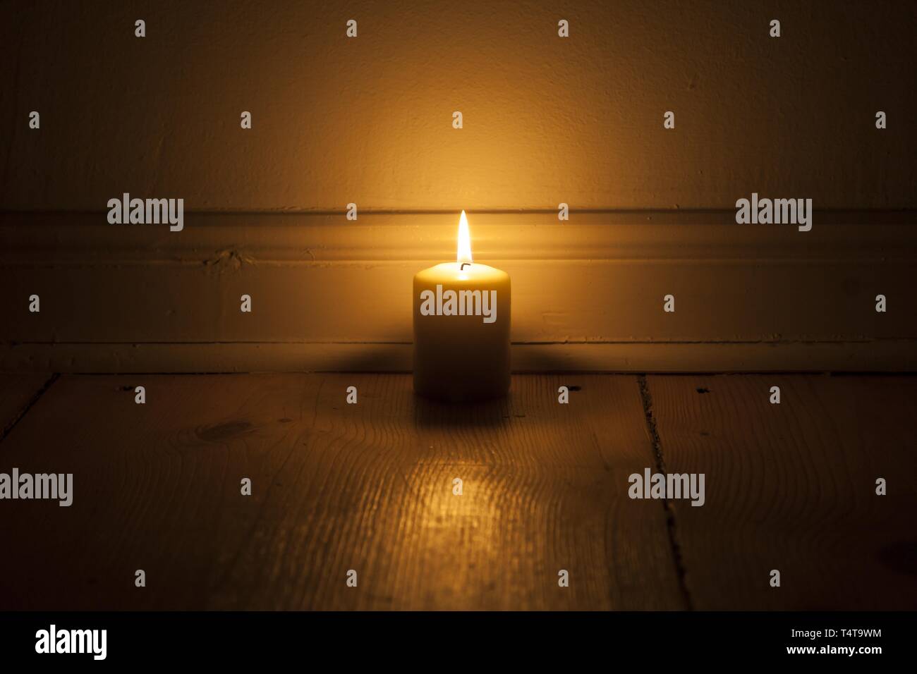 Candle on wooden floor Stock Photo Alamy