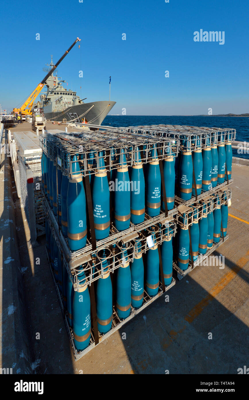 High explosive, naval artillery shell warheads, in a loading crate on a concrete wharf. The shells are awaiting delivery to an RAN frigate. Stock Photo
