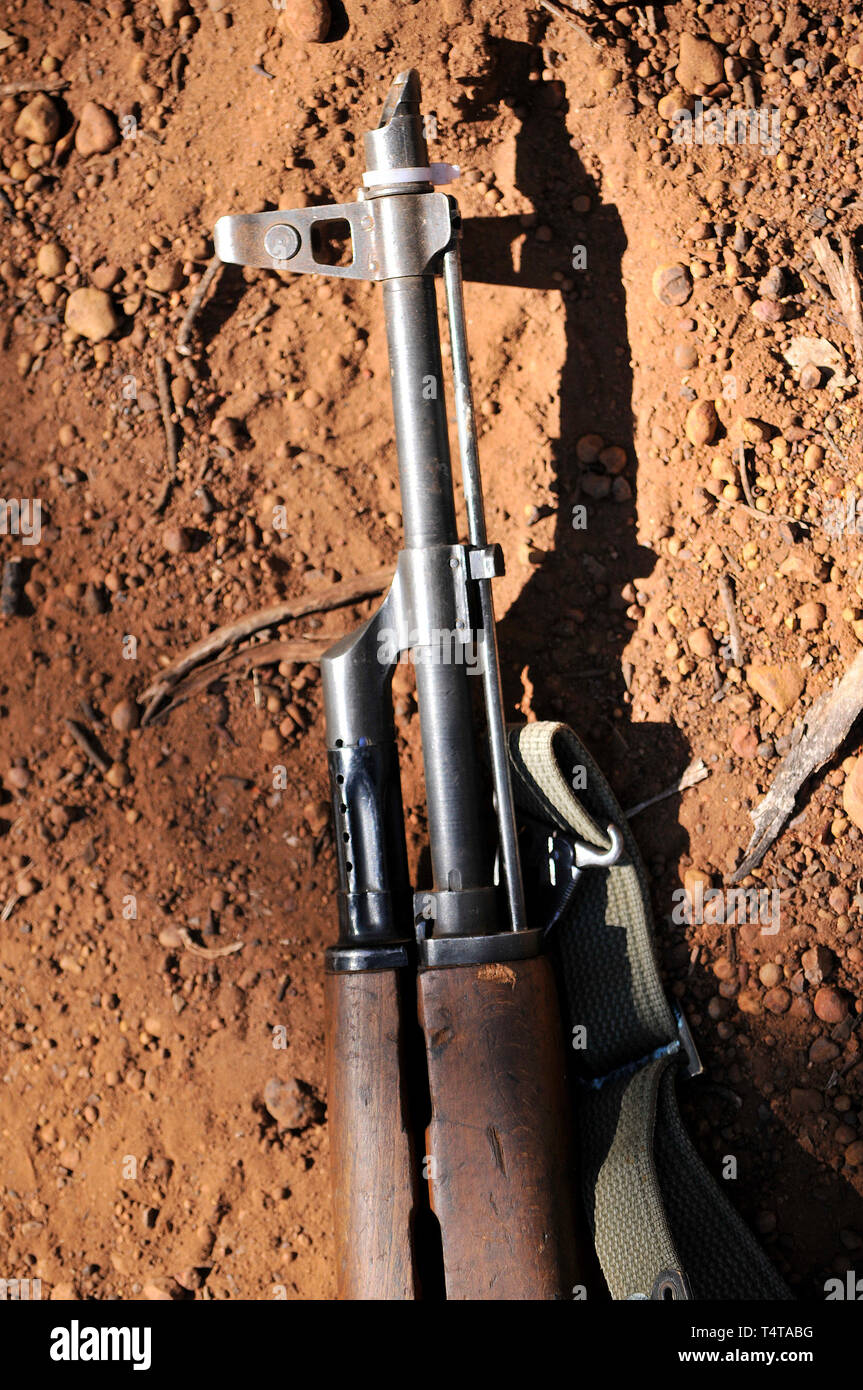 Close up of the business end of a Kalashnikov AK47 assault rifle lying in the dirt. Stock Photo