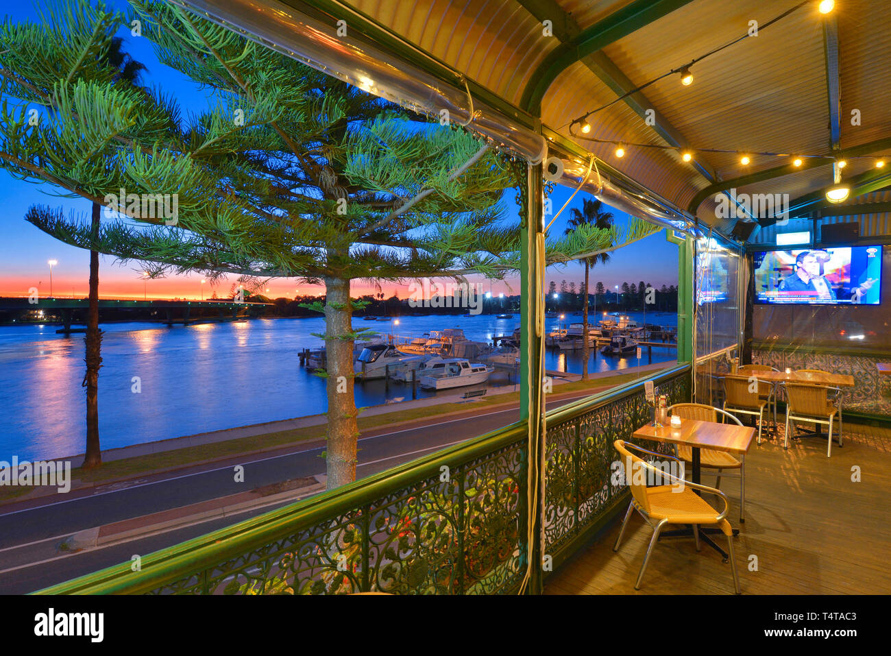 Typical Aussie pub by the Swan river, Perth, Western Australia. Taken at twilight with boats in the foreground. Stock Photo