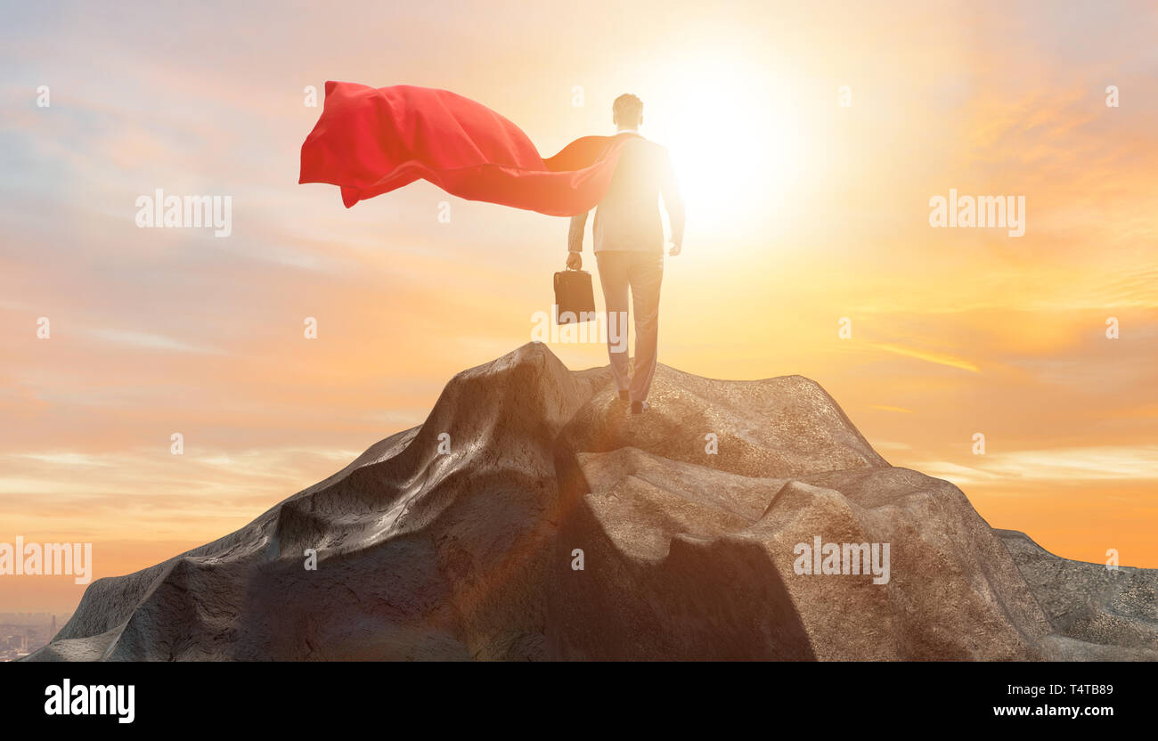 Superhero businessman on top of mountain Stock Photo - Alamy
