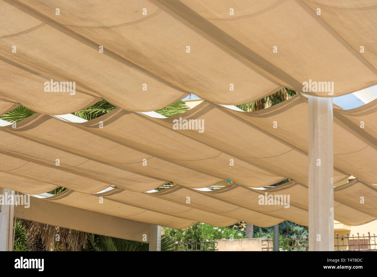 Roofing of a terrace with rope tensioning awnings Stock Photo - Alamy