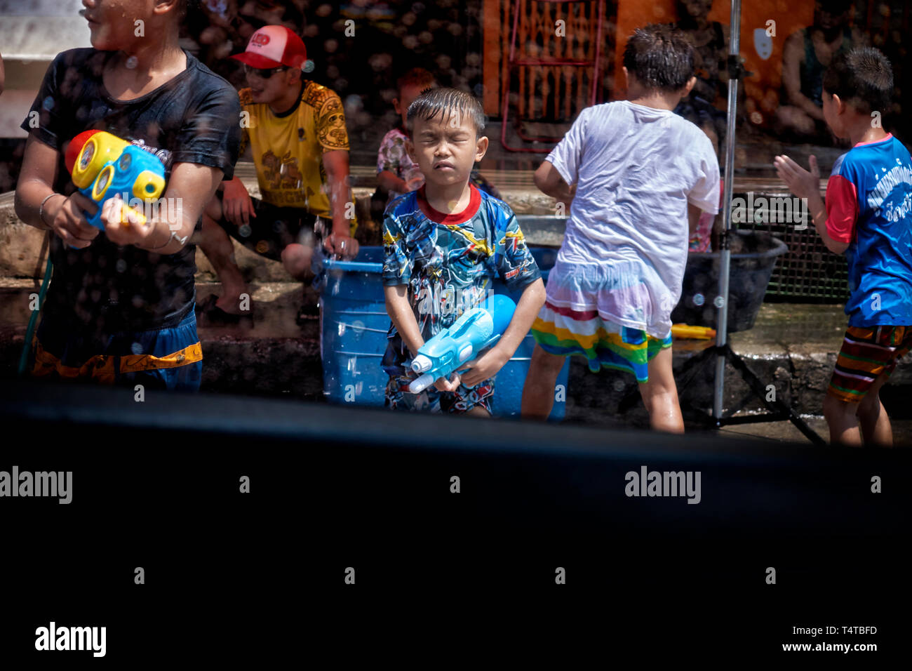 Songkran Thailand. New Year and water festival 2019 with youngsters enjoying the fun and using water guns to spray passers by. Stock Photo