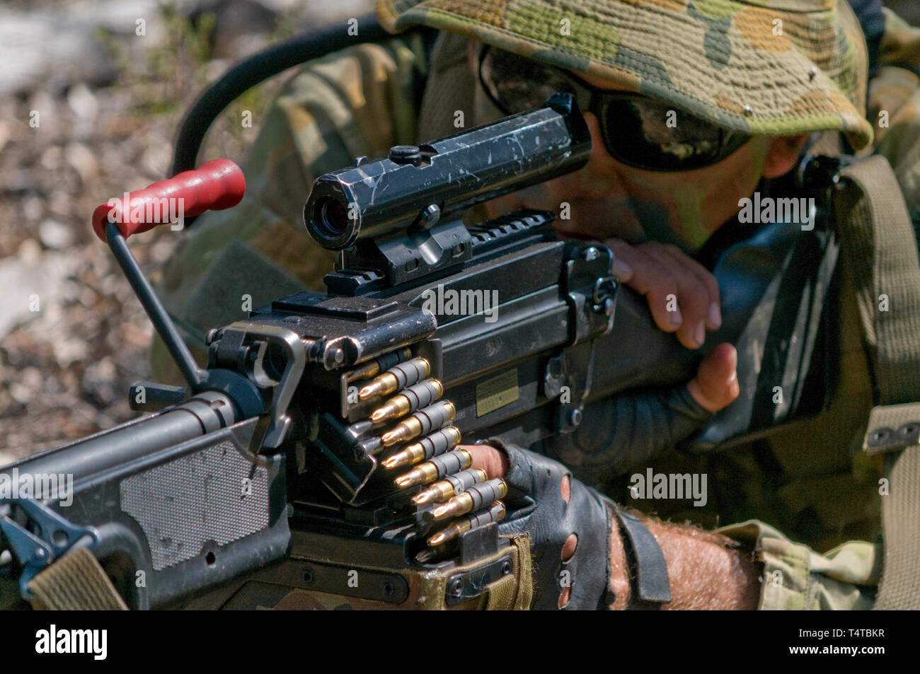 Australian Army reserve soldier aiming a Light Support Weapon (LSW) MAG 58 machine gun. He is wearing a typical 'Aussie' slouch hat. Stock Photo