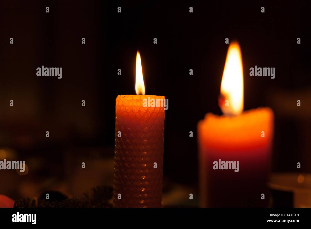 Burning beewax candle Stock Photo