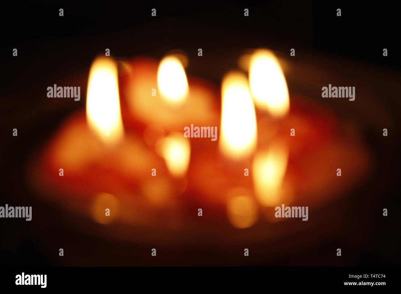 Burning candles in a bowl, blurred Stock Photo