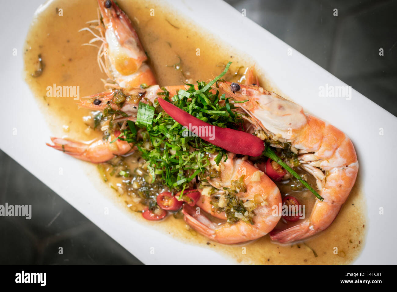 spicy asian prawns in gourmet chilli orange and coriander sauce in