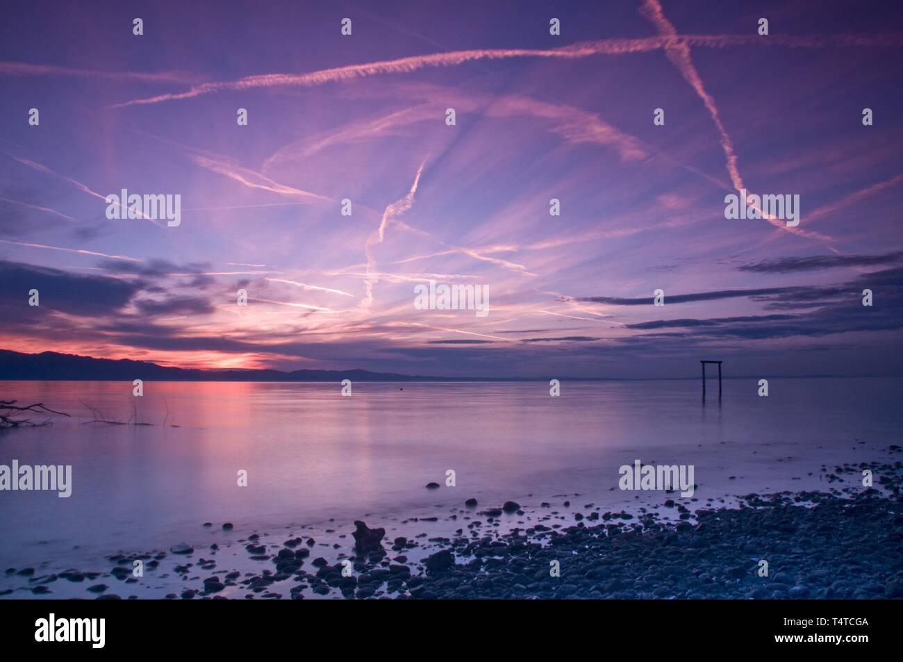 Sunset sky with contrails, Bodensee in Bad Schachen, Baden-Wuerttemberg, Germany, Europe Stock Photo