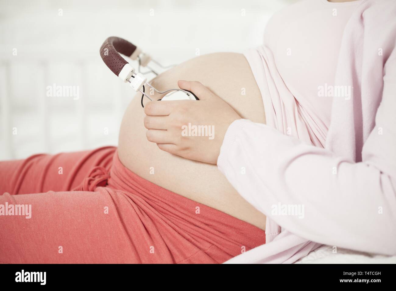 Headphones on belly hi res stock photography and images Alamy