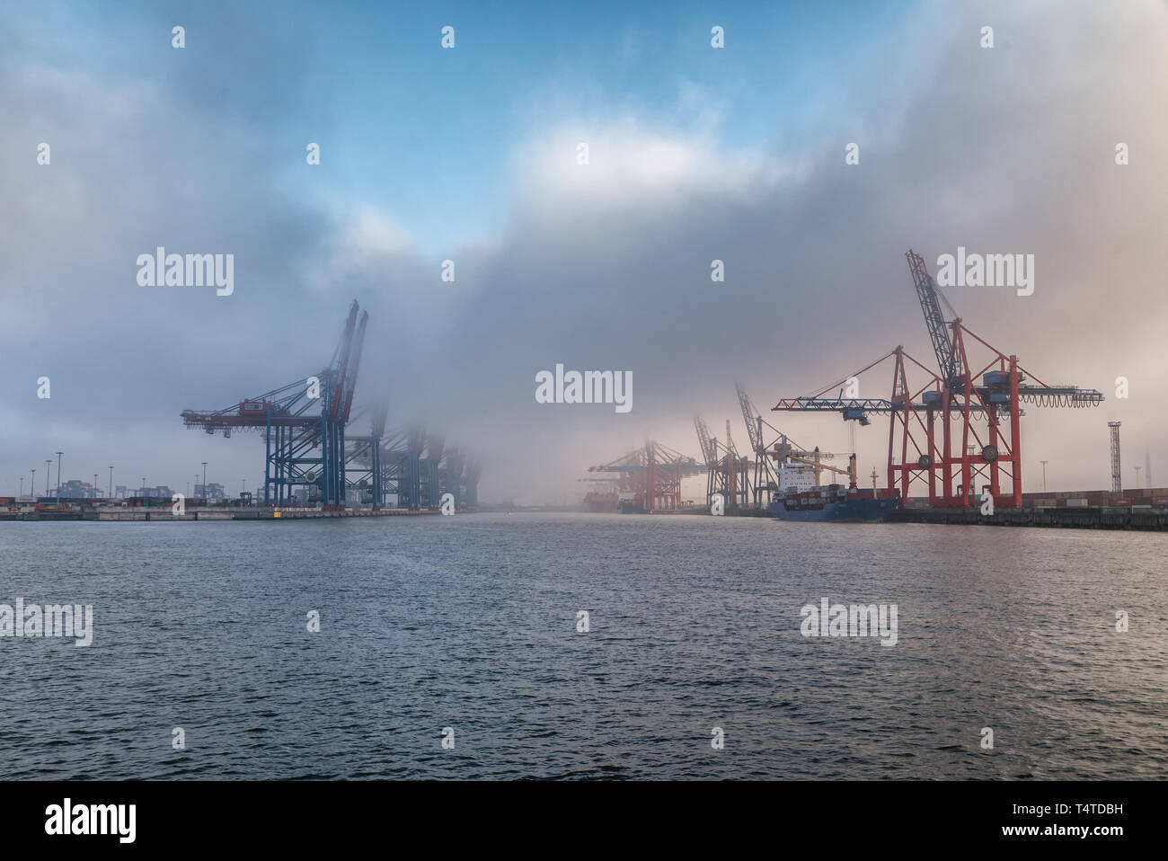 clouds over empty container terminals in the port of hamburg Stock Photo