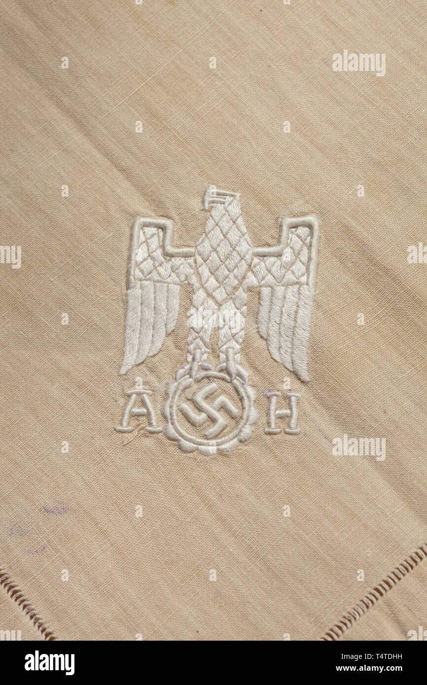 Adolf Hitler - a tablecloth for the tableware used at the Berghof, Cream-coloured linen, in one corner the national eagle embroidered in relief with monogram 'AH'. Dimensions circa 165 x 165 cm Cf. Mark D. Griffith, Collectors Guide to 'liberated' Adolf Hitler Memorabilia, p. 24, there labelled as 'informal pattern'. 20th century, 1930s, NS, National Socialism, Nazism, Third Reich, German Reich, Germany, German, National Socialist, Nazi, Nazi period, fascism, historic, historical, Editorial-Use-Only Stock Photo