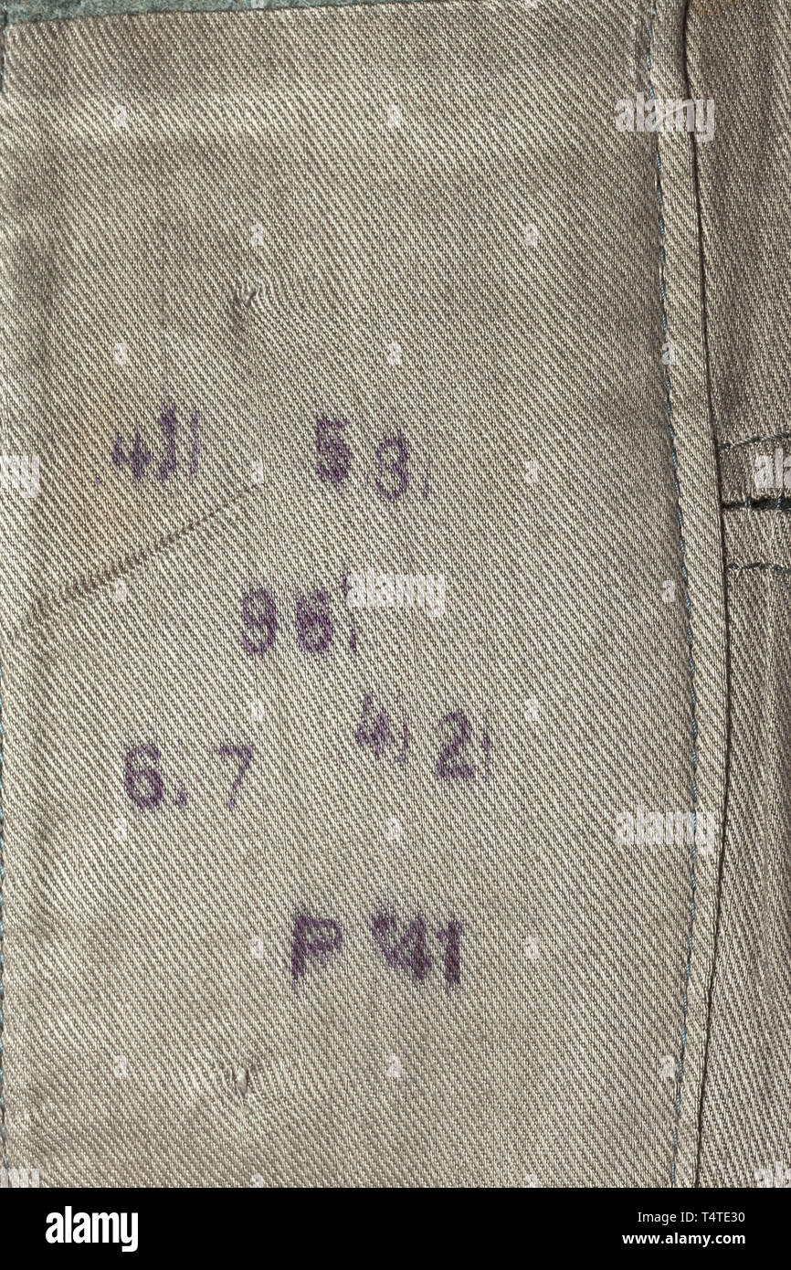 A field tunic M 40 for an Unterscharführer in the 'LAH', Field-grey cloth with five buttonholes, zinc buttons, brown inner lining with size and depot stamps, NCO braid on the collar, black collar patches with machine embroidered runes. The shoulder boards with black 'LAH' shoulder marks. The left sleeve bearing a machine sewn sleeve eagle and 'Adolf Hitler' cuff title (embroidered RZM version). Worn condition. 20th century, 1930s, 1940s, Waffen-SS, armed division of the SS, armed service, armed services, NS, National Socialism, Nazism, Third Reich, German Reich, Germany, mi, Editorial-Use-Only Stock Photo