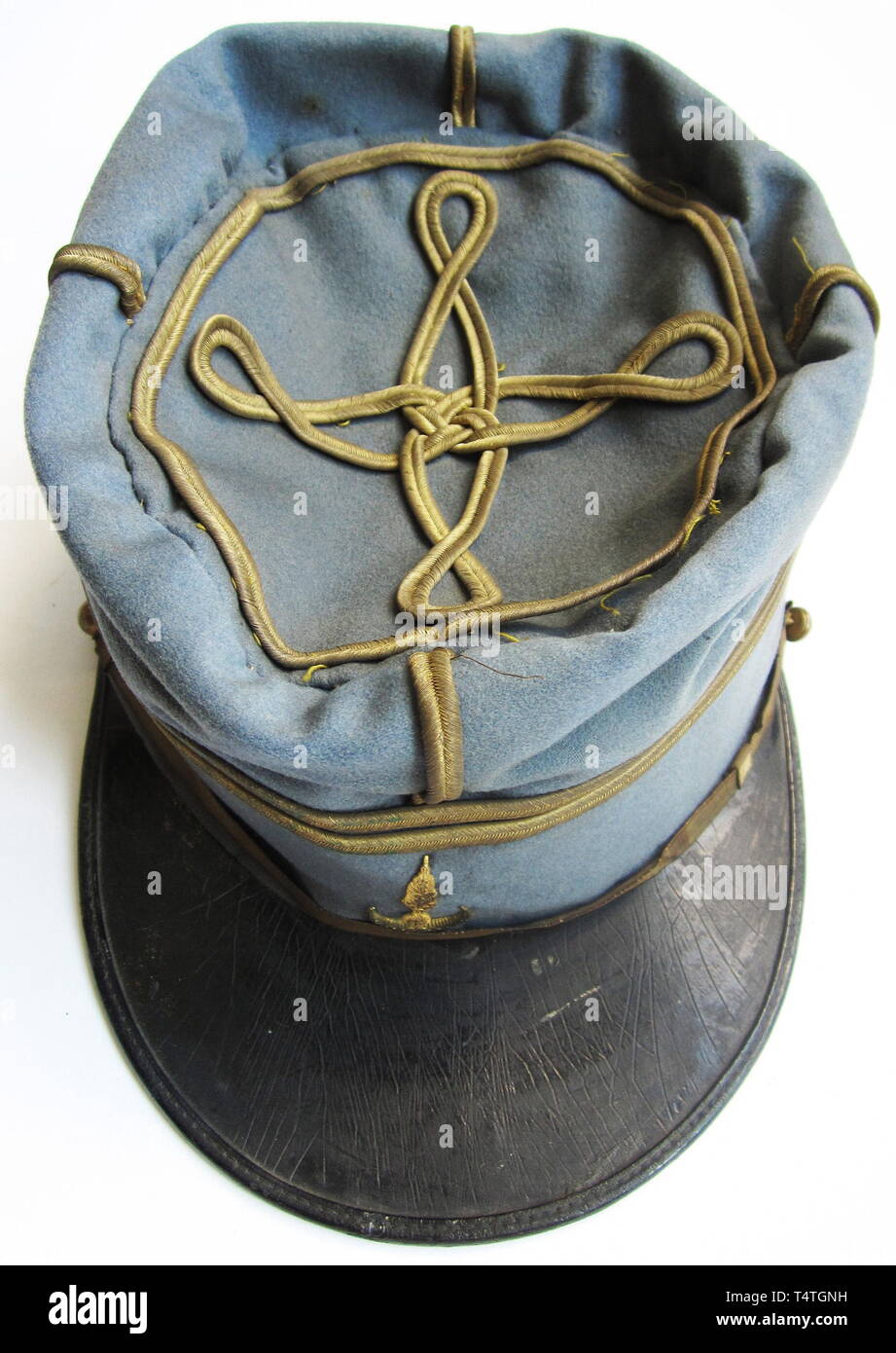 A Kepi Group for the Compagnies Sahariennes. A soft-top kepi for a lieutenant of Affaires Indigènes, (Native Affairs) 1900. Fine light blue cloth with two gold rank stripes around upper top and on vertical crown seams, and a single-looped Hungarian knot. Gold piping on crown edge. Braided wire chinstrap with two smooth gold buttons. A pressed metal badge of imitation bullion, grenade and crescent (modern a 20th century, Additional-Rights-Clearance-Info-Not-Available Stock Photo
