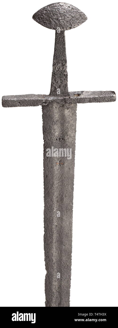 A German medieval sword, circa 1100. Double-edged blade with shallow fuller extending from top to bottom. Inscription "+ P +" on both sides, one side with remains of copper inlays. Straight quillons of rectangular section. Slightly conical tang with beautifully-shaped Brazil nut pommel. Length 97,5 cm. Provenance: Old Hessian private collection. historic, historical, sword, swords, weapons, arms, weapon, arm, fighting device, military, militaria, object, objects, stills, clipping, clippings, cut out, cut-out, cut-outs, melee weapon, melee weapons, Additional-Rights-Clearance-Info-Not-Available Stock Photo