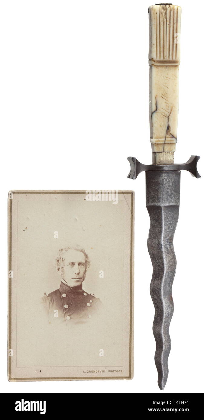 Admiral August Christian Schultz (1813 - 1908) - a naval officer's dagger, dated 1837. Dagger blade with wavy edges and a central ridge, iron quillons. Carved walrus tusk grip, engraved 'Schultz 1837'. Length 20.8 cm. Including a photograph of Admiral August Christian Schultz, who in 1868/9 commanded the frigate Jylland on her way into the Mediterranean. An interesting early naval dagger, a non-regulation model. historic, historical, 19th century, Additional-Rights-Clearance-Info-Not-Available Stock Photo