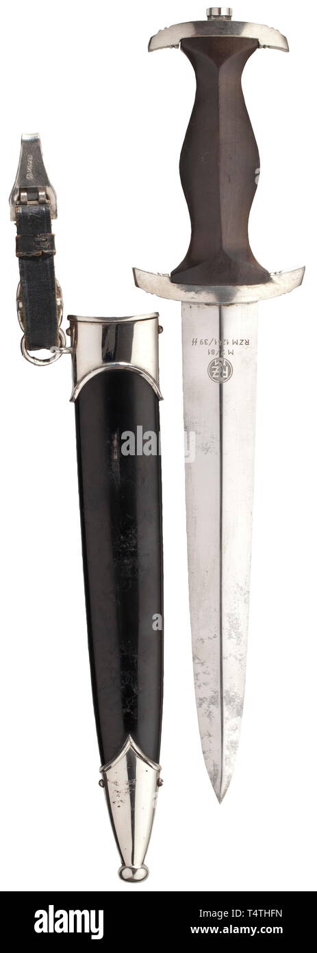 A service dagger M 33, maker Karl Tiegel, Riemberg. The blade with etched devices and etched makerïs mark 'RZM M 7/81 RZM 1241/39 SS'. Zinc quillons. Black wooden grip (the colour faded in areas) with aluminum eagle and enamelled emblem. Black painted scabbard with nickel-plated fittings and a short, black leather hanger with RZM markings. An untouched late dagger. Length 38 cm. historic, historical, 20th century, 1930s, 1940s, Waffen-SS, armed division of the SS, armed service, armed services, NS, National Socialism, Nazism, Third Reich, German Reich, Germany, military, mi, Editorial-Use-Only Stock Photo