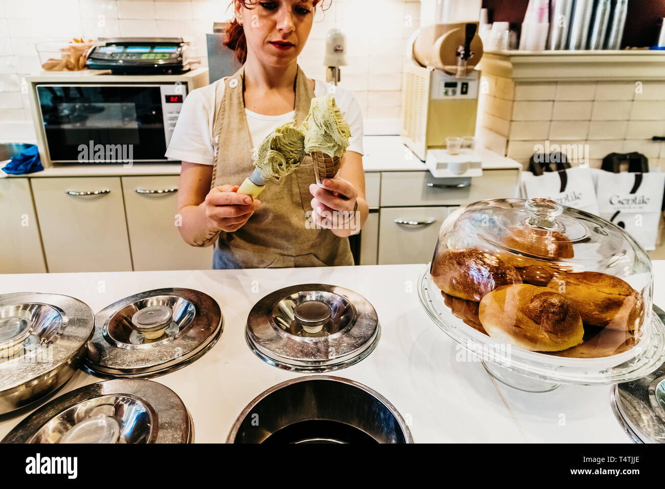 Bari, Italy March 10, 2019 Waitress in a gelateria ice cream shop