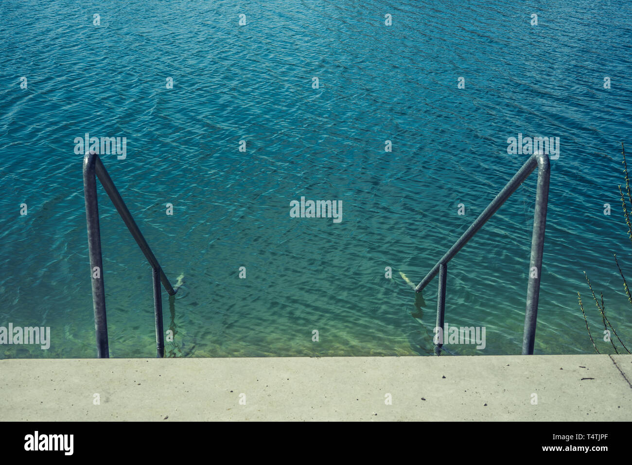 ladder in the clean lake water Stock Photo