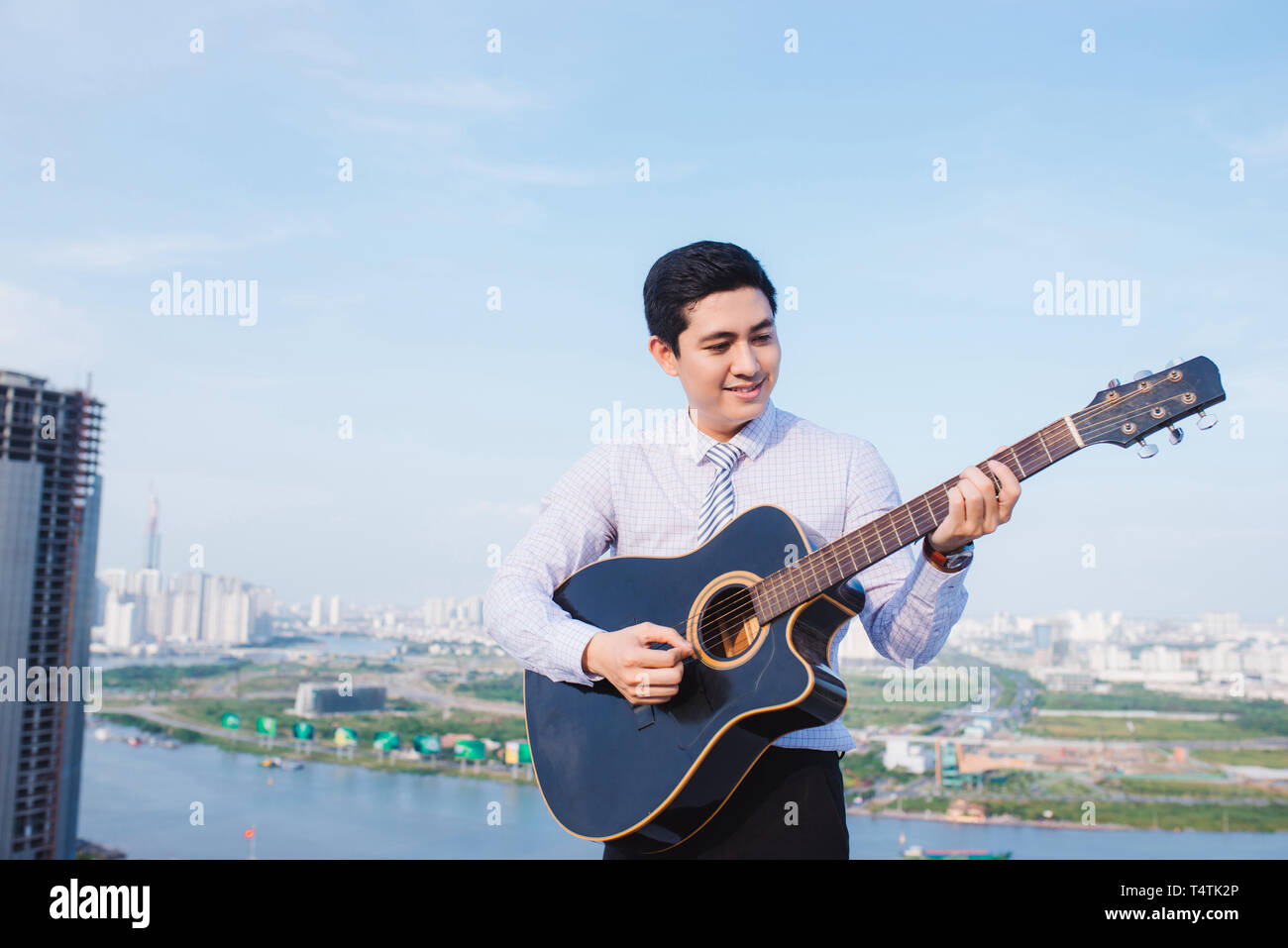 Musical Concept. Casual man playing practicing guitar. Stock Photo