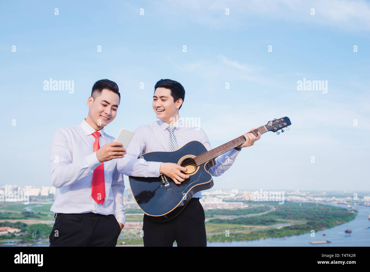 Musical Concept. Casual man playing practicing guitar. Stock Photo