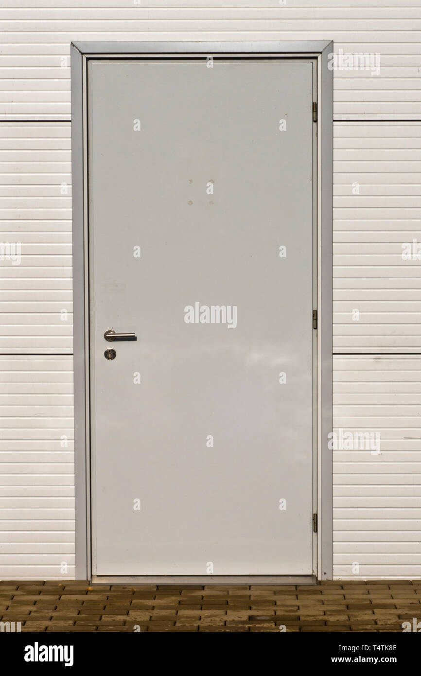 grey metal door of an industrial structure Stock Photo